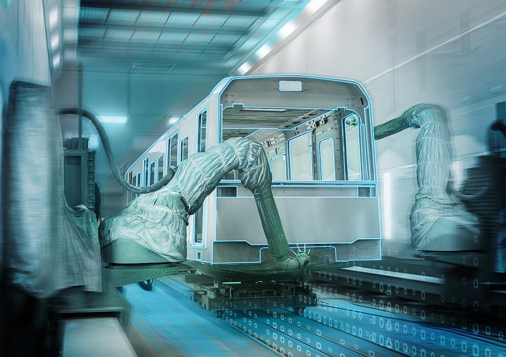 На участке обработки поверхностей завода компании Siemens Mobility в Вене роботы окрашивают стальные и металлические кузова железнодорожных вагонов